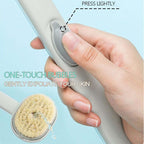 Woman using long handle shower scrubber in spa-like shower